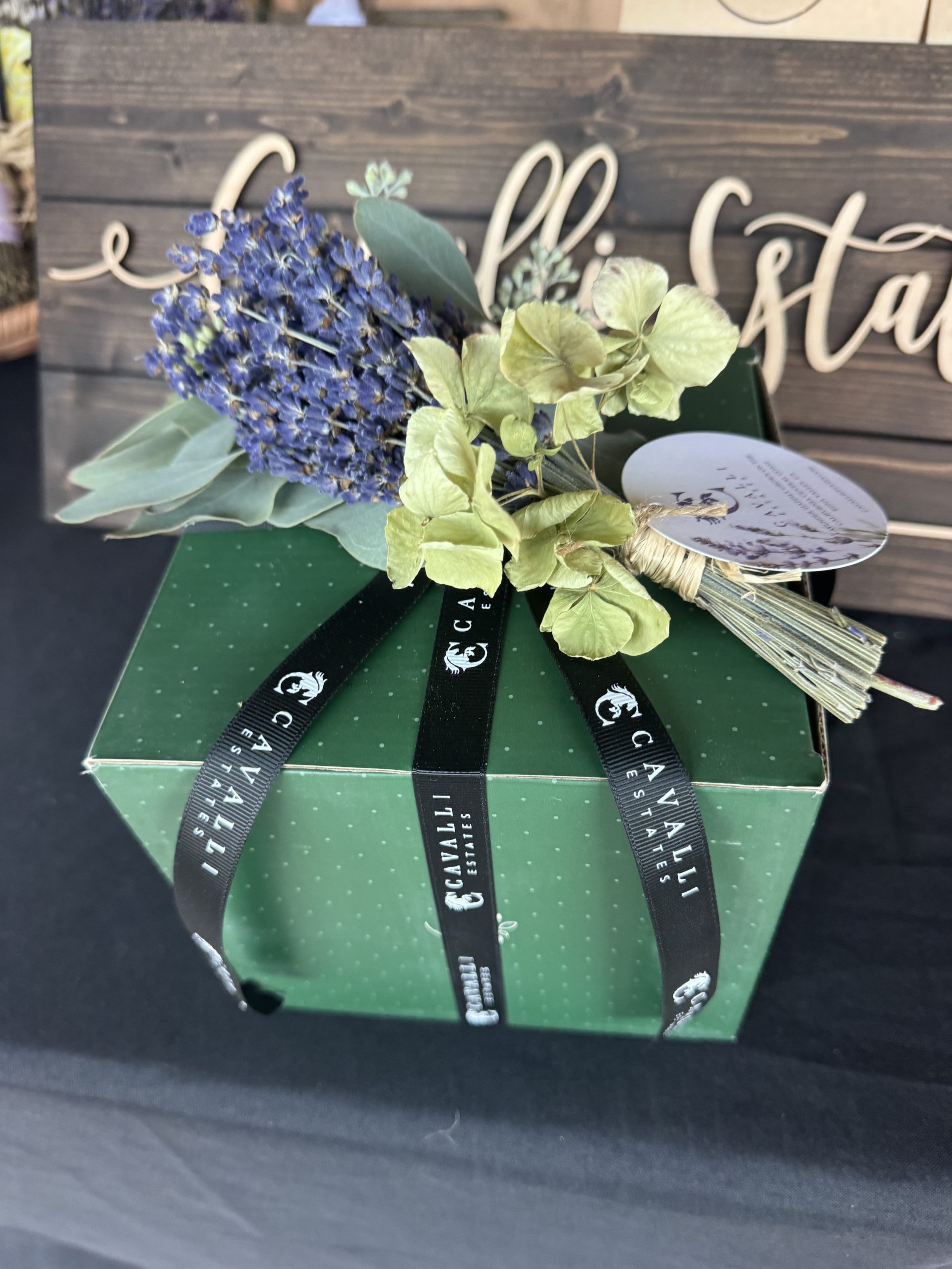 Lavender posy resting on a ribbon-wrapped Cavalli gift box